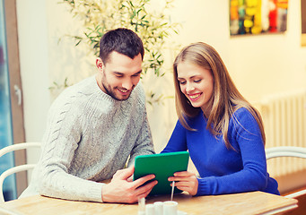 Image showing happy couple with tablet pc at cafe