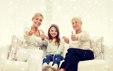 Image showing smiling family showing thumbs up at home