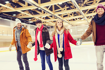 Image showing happy friends on skating rink