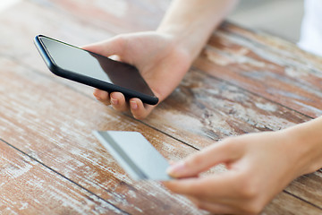 Image showing close up of hands with smart phone and credit card