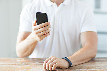 Image showing close up of man with smart phone and watch