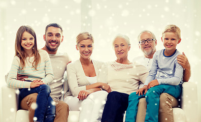 Image showing happy family sitting on couch at home