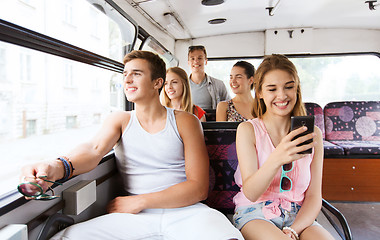 Image showing happy teenage friends traveling by bus