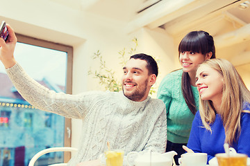 Image showing group of friends taking selfie with smartphone