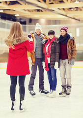 Image showing happy friends taking photo on skating rink