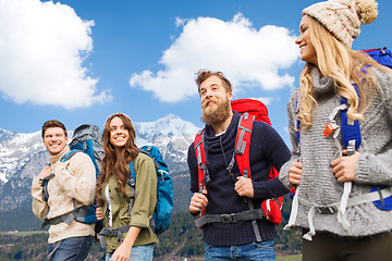 Image showing happy friends with backpacks hiking over mountains