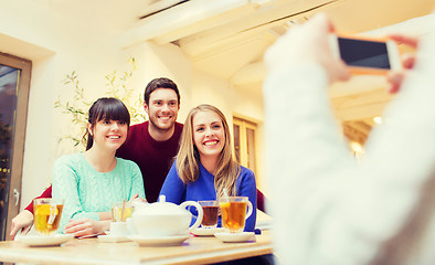 Image showing group of friends taking picture with smartphone