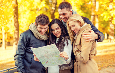 Image showing group of friends with map outdoors