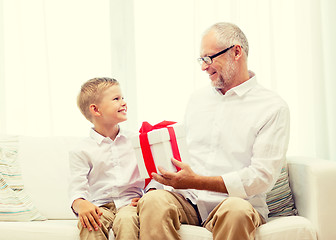 Image showing smiling grandfather and grandson at home