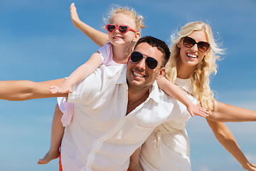 Image showing happy family having fun over blue sky background
