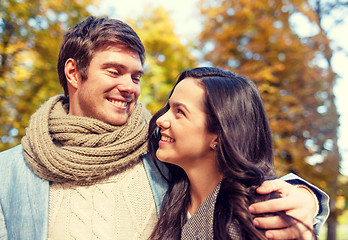 Image showing smiling couple hugging in autumn park