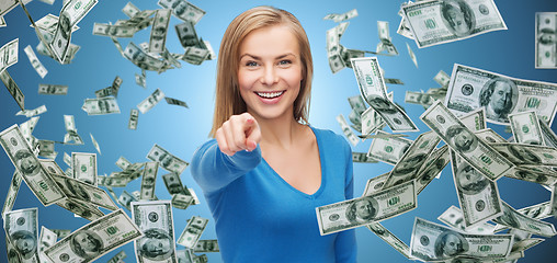 Image showing smiling woman with money pointing finger on you