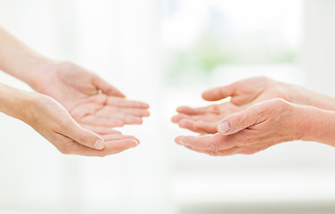 Image showing close up of senior and young woman hands