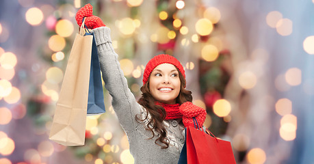 Image showing happy woman in winter clothes with shopping bags