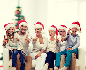 Image showing happy family sitting on couch at home