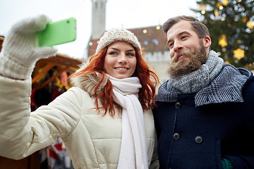 Image showing couple taking selfie with smartphone in old town