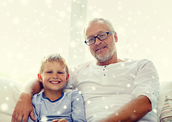 Image showing smiling grandfather and grandson at home