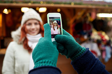 Image showing couple taking picture with smartphone in old town