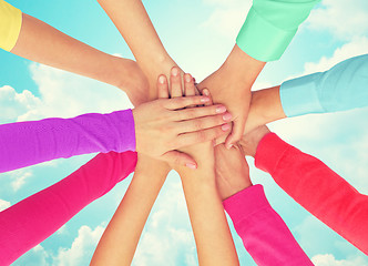 Image showing close up of women hands on top in rainbow clothes