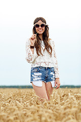 Image showing smiling young hippie woman on cereal field