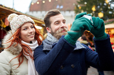 Image showing couple taking selfie with smartphone in old town