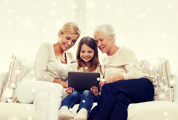 Image showing smiling family with tablet pc at home