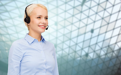 Image showing helpline operator in headset over grid background