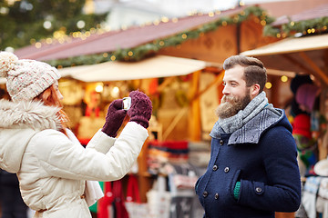 Image showing couple taking selfie with smartphone in old town