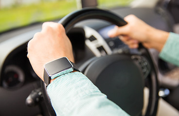 Image showing close up of man with wristwatch driving car