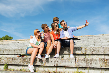 Image showing happy friends with smartphone taking selfie