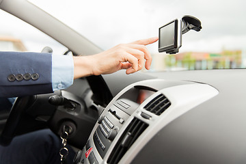 Image showing close up of man with gps navigator driving car