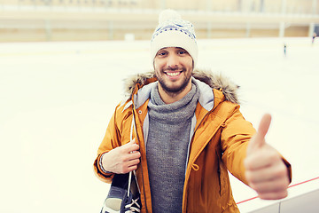 Image showing happy young man showing thumbs up on skating rink