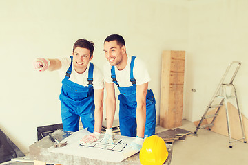 Image showing group of builders with blueprint