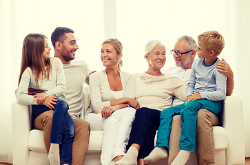 Image showing happy family sitting on couch at home