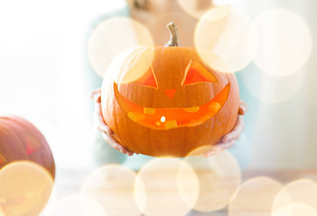 Image showing close up of woman with pumpkins at home