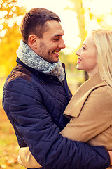 Image showing smiling couple hugging in autumn park