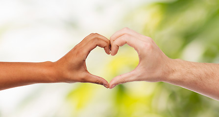 Image showing woman and man hands showing heart shape