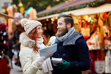 Image showing happy couple with map and city guide in old town