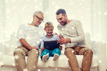 Image showing smiling family with tablet pc at home