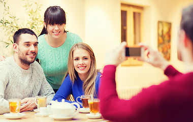 Image showing group of friends taking picture with smartphone