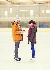 Image showing happy couple with engagement ring on skating rink