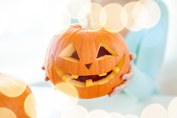 Image showing close up of woman with pumpkins at home