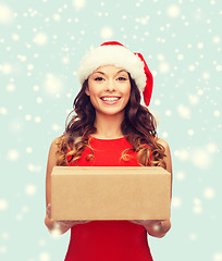 Image showing smiling woman in santa helper hat with parcel box