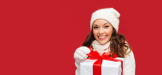Image showing smiling woman in white clothes with gift box