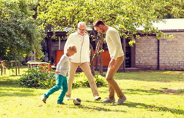 Image showing happy family playing football outdoors
