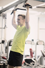 Image showing smiling man exercising in gym