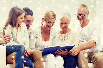 Image showing happy family with book or photo album at home