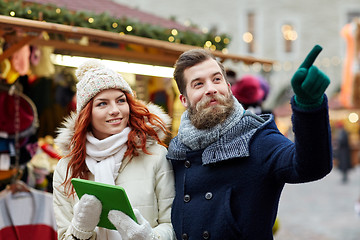 Image showing happy couple walking with tablet pc in old town