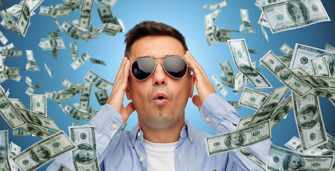 Image showing surprised man under dollar money rain