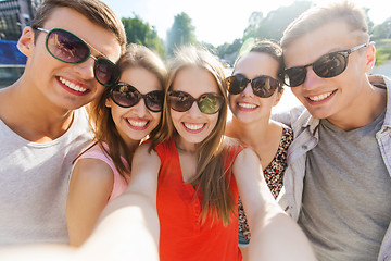 Image showing smiling friends taking selfie